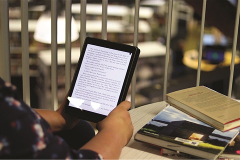 eBook being read on an iPad at a coffee table.